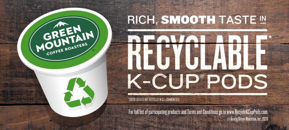 An image of a Keurig Green Mountain coffee pod to the left, with a recycle sign on its body. To the right is text as follows: “RICH, SMOOTH TASTE IN RECYCLABLE* K-CUP PODS”, and underneath in smaller print: “*CHECK LOCALLY, NOT RECYCLED IN ALL COMMUNITIES”. The background is made of old wooden planks.